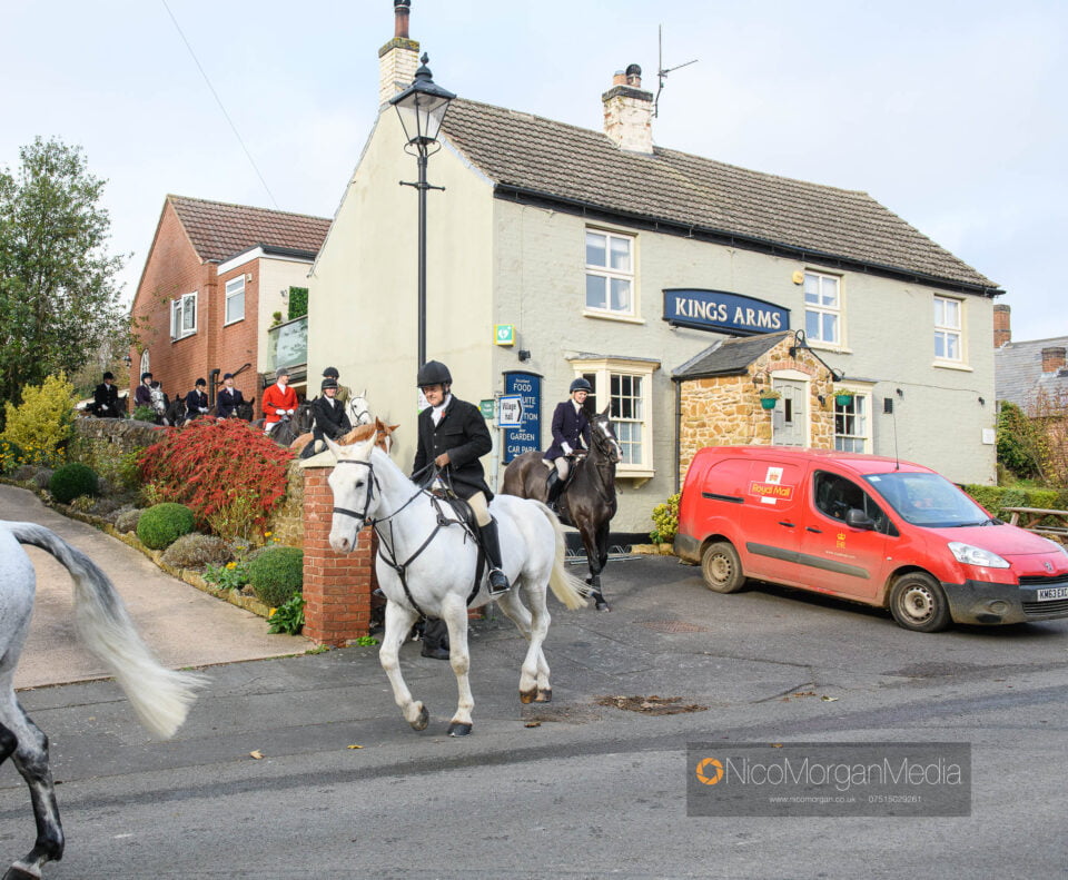 The Kings Arms, Scalford, with horse riders going past The Kings Arms, Scalford, with horse riders going past